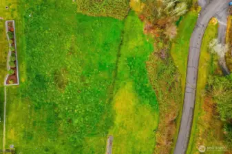 Birds eye view of 0.964 acre lot. Road to community beach boarders on east edge.