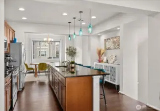 Expansive island with bar seating creates a central gathering point