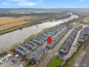 Captures the Snohomish River as a peaceful natural backdrop right behind the community