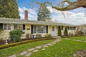 Charming single-level rambler with mature landscaping and inviting curb appeal.