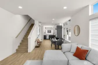 Central living level with open staircase connects seamlessly from living to kitchen for effortless entertaining.