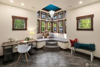 Carpeted bench in turret is the perfect place to read, work puzzles or play games