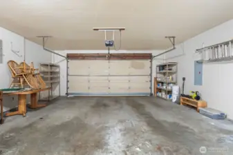 Big garage with built in work bench. New water heater and recently serviced water heater in side room here. LOTS of attice storage space