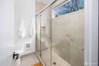 Large full tiled shower in primary bathroom.