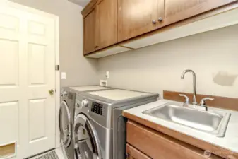 Laundry/Storage room off the garage with new sink. storage, storage, storage. Washer & Dryer stays!