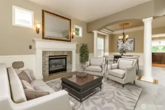 Look at the extra details of the formal room real brick gas  fireplace surrounded by wood mantle & wainscoting