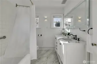 Updated main-level full bath featuring the original cast-iron tub.