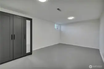 One of two lower-level non-conforming bedrooms each similar in size