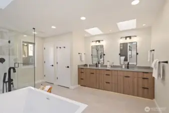 The primary bathroom features a soaking tub and skylights that perfectly brighten the space.
