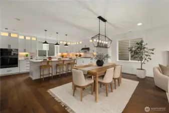 Dining Area: Open dining space seamlessly connects kitchen and great room, anchored by a modern statement chandelier and wide-plank hardwood floors. Large windows provide natural light, creating a warm and welcoming setting for gatherings in the heart of Bothell’s Canyon Park.    Photos are from the model home at Foxmoore and for visualization purposes only. Plans, colors, building orientation, finishes, home outlook, and other details can and WILL vary.