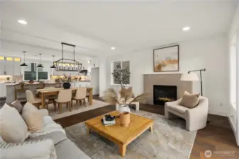 Great Room: Light-filled great room centers on a sleek gas fireplace framed by tile surround and expansive windows. The open layout blends comfort and sophistication, with direct flow to dining and kitchen for effortless entertaining.    Photos are from the model home at Foxmoore and for visualization purposes only. Plans, colors, building orientation, finishes, home outlook, and other details can and WILL vary.