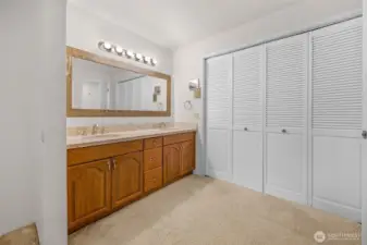 Vanity for primary bedroom with walk in close doors shown