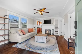 Inviting Living Room with Wood-Burning Fireplace and Gleaming Hardwood Floors