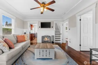 Charming Living Room with Wood-Burning Fireplace and Rich Hardwood Floors