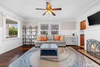 Bright Living Room with Cozy Fireplace and Gleaming Hardwood Floors