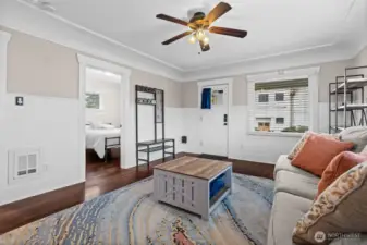 Welcoming Living Room with Classic Craftsman Entry Door and Hardwood Floors