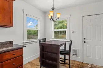 Bright Dining Area with Dual Windows and Chandelier