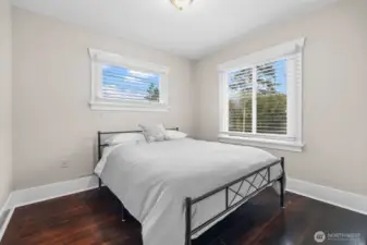 Sun-Filled Bedroom with Rich Hardwood Floors and Dual Windows