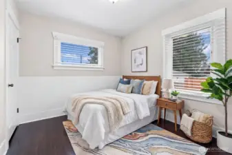 Charming Bedroom with Beadboard Wainscoting and Hardwood Floors