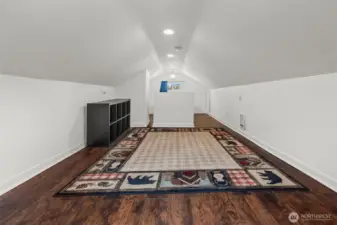 Expansive Bonus Room with Vaulted Ceilings and Rich Hardwood Floors