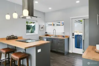 Butcher block countertops and stylish fixtures highlight the kitchen.