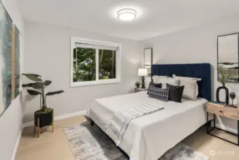 Welcome to the second main floor bedroom, offering serene views of trees and gardens through its large window. With luxury laminate flooring throughout, consistent with the rest of the house, this space provides a peaceful retreat amidst nature's splendor.
