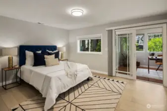 The second upstairs bedroom features elegant glass French doors that open to a sunny enclosed balcony. This charming space is filled with natural light, providing a perfect retreat within the home.
