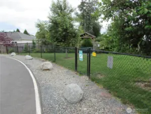 Covered shelter inside fenced dog park in Comm.