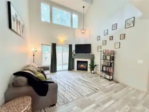 Great room with cozy fireplace and vaulted ceilings.