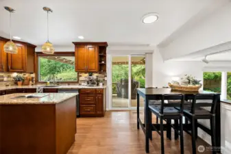 The kitchen has a glass sliding door out to the covered deck and a breakfast nook area.
