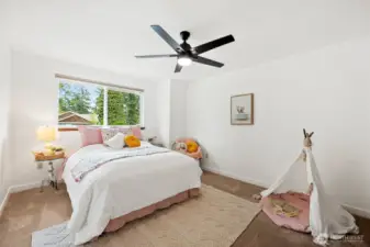 The two additional upstairs bedrooms are large and have big windows to bathe the rooms in natural light.