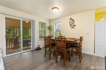 Dining area. Sliding door leads to the covered back deck and walking trails.