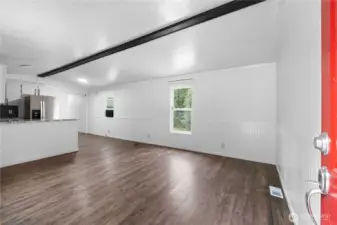 Open the door to the living area that is open and light and bright, newer flooring, bright paint, wainscotting and more!