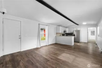 From the opposite corner you can see the kitchen and the hallway to the other two bedrooms!