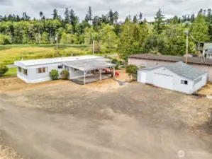 The home has a covered carport, patio and detached garage with shop and storage space.