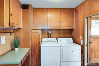 Laundry area with lots of storage, folding table and exit to the rear porch & door.