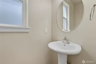 Half bath on the main level, notice a frosted window for natural light