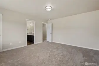 Primary bedroom showing entrance to ensuite bathroom