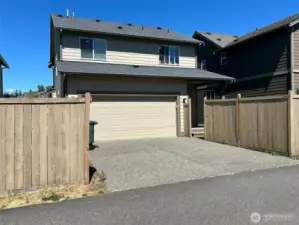 Rear view from paved alley, gate to the right leads to back yard.