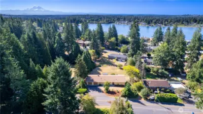 This breathtaking drone shot captures the property’s setting—just minutes from Lake Meridian with a backdrop of Mount Rainier. You get the best of both worlds: peaceful privacy among the evergreens and quick access to waterfront recreation. The neighborhood is dotted with charming homes and tree-lined streets, while the view beyond showcases why this area is so desirable. This image tells the story of location—natural beauty, community, and accessibility all in one.