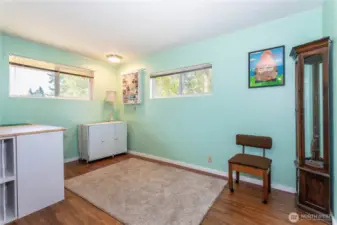 This flex space is a true bonus—perfect for hobbies, a home office, or an additional bedroom. With large windows on two walls, the room is filled with natural light, making it an inspiring spot to work or create. The calming aqua walls add a fresh, modern touch, while durable flooring keeps it practical. This is the kind of adaptable space buyers love—big enough to grow into, yet cozy enough to stay functional for daily living.