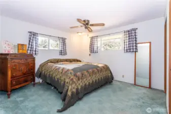 The primary bedroom offers comfort and space, featuring dual windows for light and airflow. The layout makes it easy to accommodate larger furniture while still feeling open. With a ceiling fan, ample closet space, and room to personalize, it’s a blank canvas ready to fit your lifestyle. The atmosphere is peaceful, tucked away for privacy, and provides a restful retreat at the end of the day.