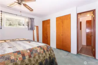 From this angle, you see the generous storage with dual closets and convenient access to the hallway. Natural light continues to brighten the space, and the layout shows how practical and functional this bedroom is. The room is well-proportioned, making it easy to design around, whether you prefer a minimalist look or a fully furnished retreat. It’s a versatile owner’s suite with potential to modernize to your taste.