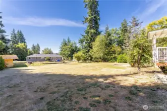The backyard is a true highlight—spacious, level, and full of potential. It’s large enough for sports, pets, or even a future garden or play area. Surrounded by trees for privacy and greenery, this yard is a blank canvas ready for your personal vision. Whether you want wide open lawn space or a custom outdoor retreat, the possibilities here are endless.