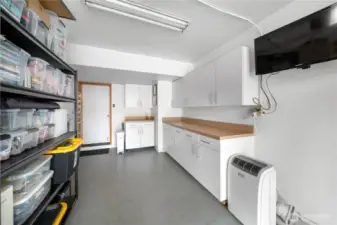 Spacious attached single car garage with built-in storage cabinets.