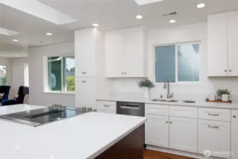 Bright & light chef's kitchen offers high-end SS Cafe fridge, Bosch dishwasher, quartz countertops & a pantry w/ a pull-out shelf system.