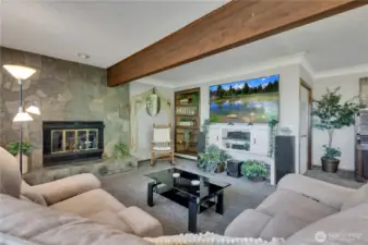 Inviting living room featuring a gas fireplace, built-in shelving, and large closet.