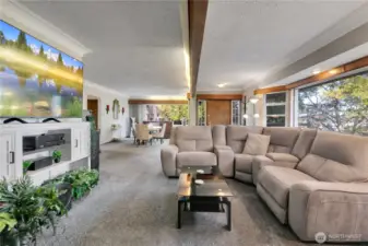 Open living/dining areas w/exposed beam & large windows.