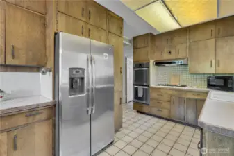 Kitchen features a stainless-steel refrigerator.