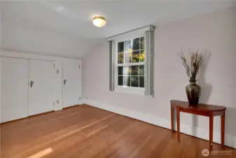 Bedroom at end of hall w/window overlooking side yard.
